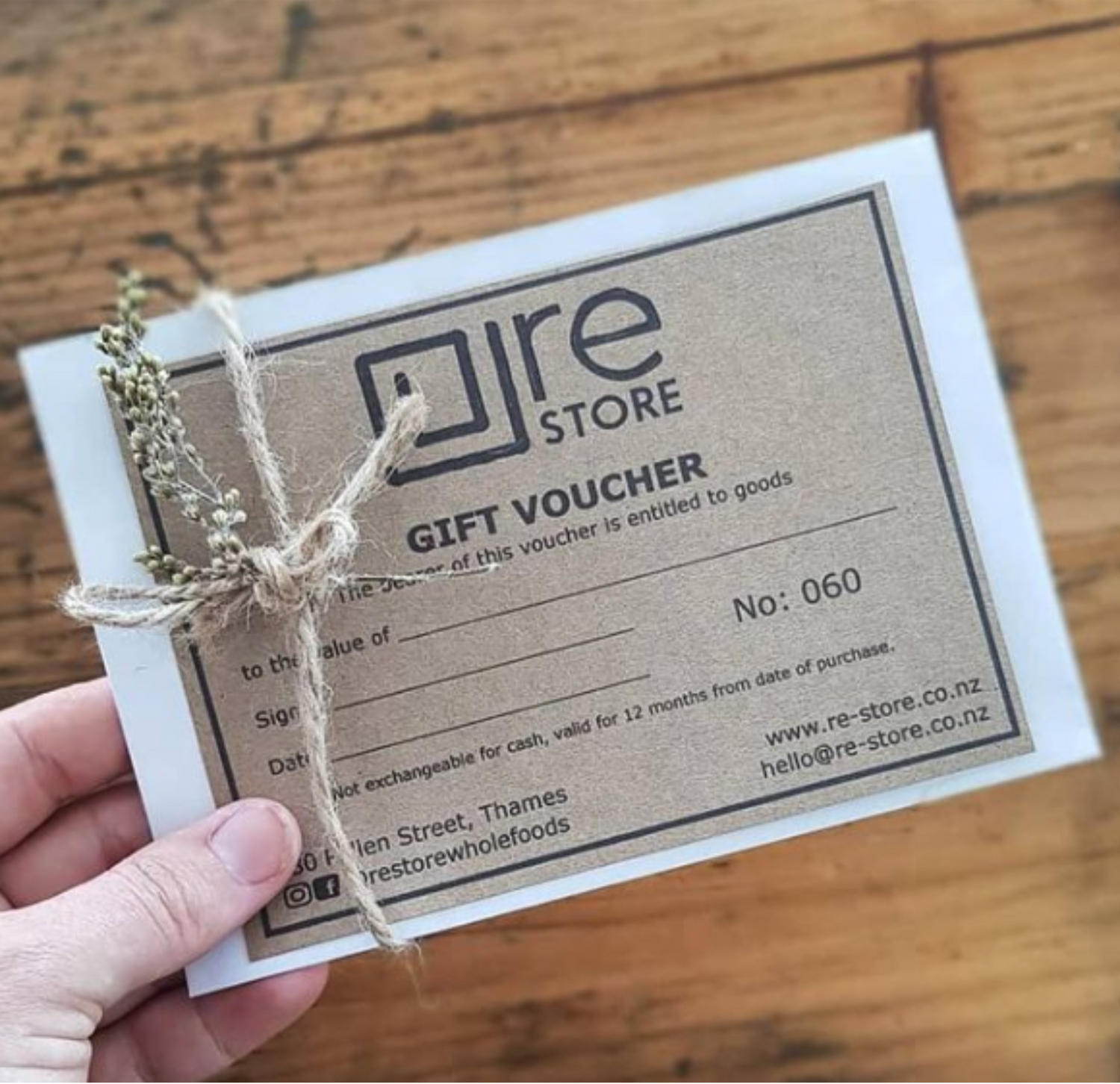 Person holding a re-store eco friendly gift voucher